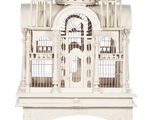a white bird cage with a building on top of it