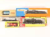 three boxed trains sitting next to each other on a white surface