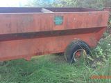 a red trailer that is parked on the side of the road