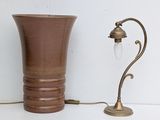 a brown vase and a lamp on a white table