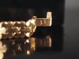 a close up of a gold ring on a table