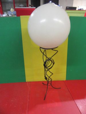 a balloon that is attached to a stand on the floor