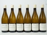 six bottles of wine are lined up in a row on a table