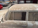 many old cars parked in a parking lot