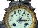a statue of a man standing on top of a clock