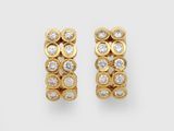 a pair of gold and diamond earrings
