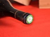 a bottle of wine sitting on a red table