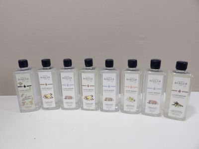 six bottles of hand sanitizer are lined up on a table