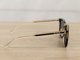 sunglasses on a wooden table with a white wall in the background