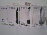three boxes of sony headphones sitting on top of a white table