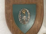 a plaque on the wall next to a cross and a plaque on the wall