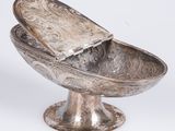 a silver bowl with a silver lid on a stand
