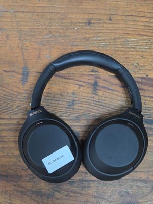 a pair of headphones sitting on top of a wooden table