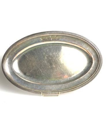 a silver plate with a silver rim on a white surface