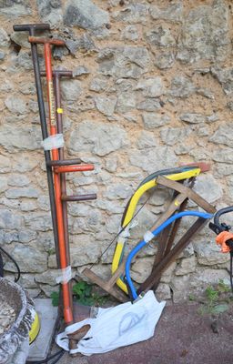a scooter that is parked next to a stone wall