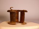 a sculpture of a cat sitting on top of a wooden stand