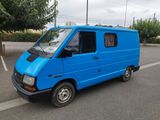 a blue van that is parked on the side of the road
