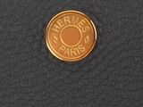 the leather wallet has a gold coin on it ' s side