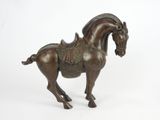 statue of a horse with a saddle on its back on a white background
