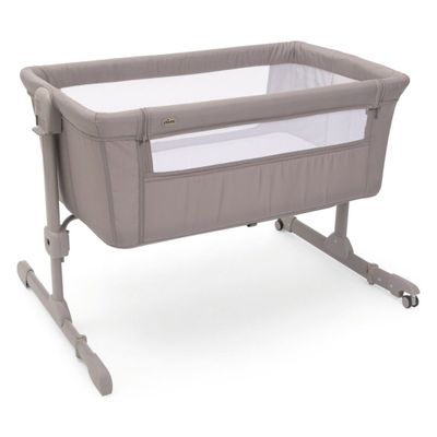 a close up of a baby crib with a white sheet in it