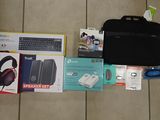 a laptop, headphones, a keyboard, a mouse, and other items laid out on the floor