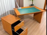 an image of a desk with a glass top and drawers