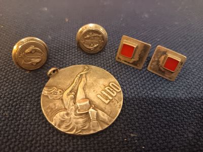three gold and red enamel cufflinks and a silver coin