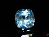 an image of a blue topaz diamond on a black surface