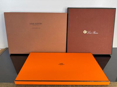 two boxes of louis vuitton are sitting on a table