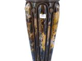 a vase that is sitting on a stand on a white background