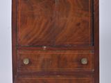 an antique wooden chest of drawers with brass hardware on top