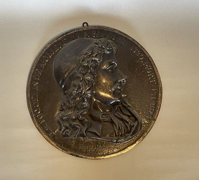 an image of a medal with a man ' s face on it