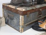 many pairs of shoes sitting on top of a trunk