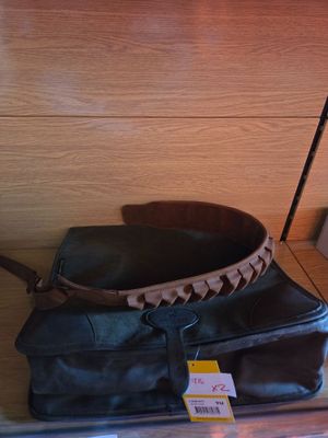 a black bag and a brown bag on a shelf