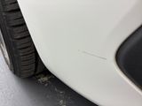 a close up of a tire on a white car