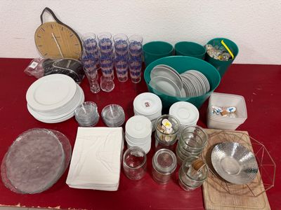 a red table with a bunch of dishes and cups on it