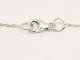 a close up of a silver chain with a heart on it