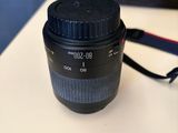 the camera lens is sitting on the table next to the bag