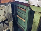 a green workbench with drawers on it in a workshop