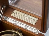 a wooden box with a clock inside of it