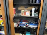 a bookcase with many books on it in a room