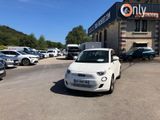 a small white car parked in front of a building