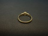 a close up of a gold ring on a black surface