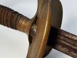 a close up of a sword with a metal handle
