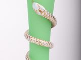 a green vase with a snake wrapped around it