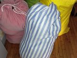 three bags of laundry sitting on the floor next to each other