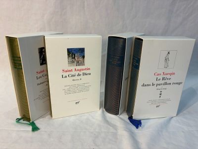 three books sitting on top of a white table next to each other