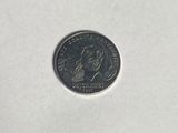 a close up of a small coin on a white surface