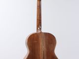 an acoustic guitar hanging from a string on a white background