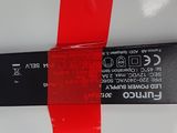 a close up of a red ribbon on a white surface